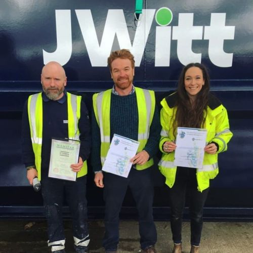 Accreditations - Jamie Witt and Amy Wilkinson with a colleague standing in front of a JWitt Waste management truck with their qualifications and Accreditations